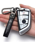 Hand holding Mercedes Benz Tire Valve Caps And Leather Keychain Set featuring a Mercedes-Benz key with premium leather strap