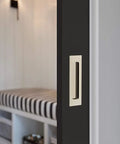 Close-up of Emtek Modern Rectangular Flush Pull Handle 1-3/4 X 4 Inches Satin Nickel Finish installed on a dark door.