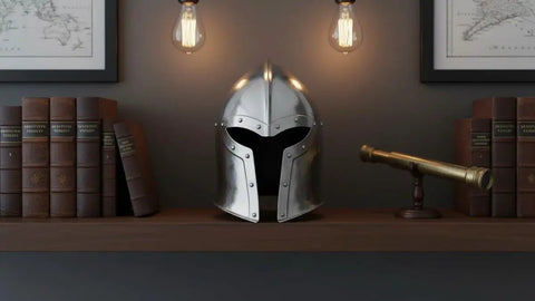 Medieval Barbuta Helmet With Liner for Larp, Cosplay, Halloween and Theatrical Props displayed on a shelf with books and telescope.