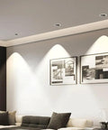 LED Recessed COB Spotlight illuminating artwork on wall above a couch in a modern living room.