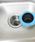 Go-To Kitchen Sink Strainer 4 Pack Silicone Drain Filters With Wide Rim 4.5 Inch Diameter in blue, shown on a stainless steel sink.