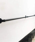Sturdy black wall-mounted stainless steel handrail for safety near stairs, showcasing its solid construction and sleek design.