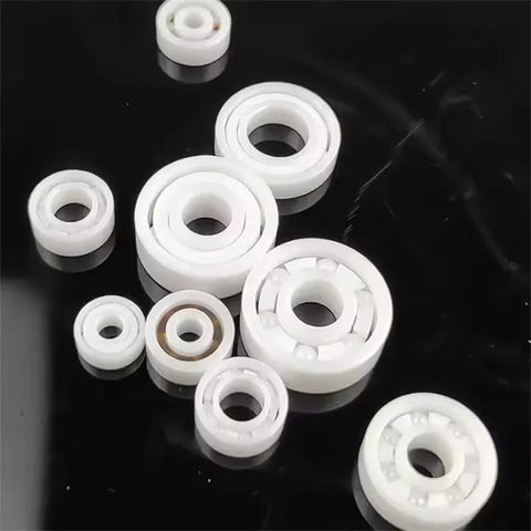 Top-down view of white 608 ceramic bearings set (8x22x7mm) on black surface; several pieces visible