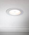 5 Inch And 6 Inch Retrofit LED PIR Motion Sensor Downlight installed in white ceiling, round trim with center sensor