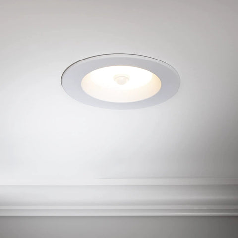 5 Inch And 6 Inch Retrofit LED PIR Motion Sensor Downlight installed in white ceiling, round trim with center sensor