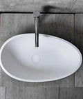 Real Deal White Oval Vessel Sink Built Tough From Dense Artificial Stone For Quick Countertop Installation With A Slick Finish. Top view.
