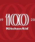 Limited Edition Queen Of Hearts Corded Hand Blender In Bold Passion Red with KitchenAid 100th Anniversary logo in white on red background.