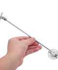 Hand holding Six Pack Cabinet Door Support Rods For Kitchen Cabinets In Heavy Duty Iron, Drop Down Lift Prop Hinge