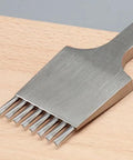 Close-up of an 8-tooth Leather Pricking Iron Chisel In French Style Die Steel Punch Tool 3.85mm for Leathercraft Pros on a wooden surface.