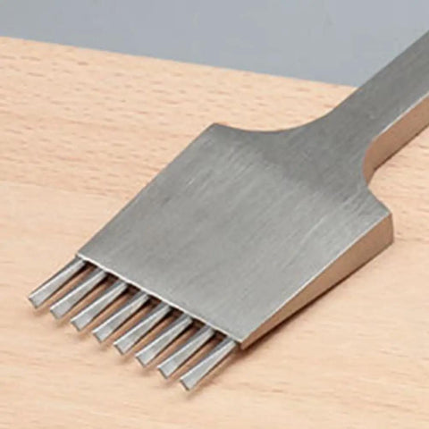 Close-up of an 8-tooth Leather Pricking Iron Chisel In French Style Die Steel Punch Tool 3.85mm for Leathercraft Pros on a wooden surface.