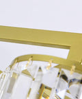 Close-up of Modern Ceiling Pendant Light Featuring Transparent Crystal And Polished Gold Cylinder Frame, showcasing the gold frame detail.
