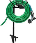 Outdoor Shepherd Hook With 5 Prong Base Bird Feeder Pole Stand holding a garden hose with nozzle attachment, black metal
