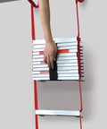 Hand holding a folded Retractable 3-Story Fire Escape Ladder 25 Feet For Home Emergency Safety with red ropes and silver rungs
