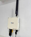 Heavy Duty M02 LoRaWAN Gateway With PoE And LTE Cat4 Backhaul mounted on a wall with antennas, ideal for edge systems.