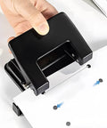 Heavy-Duty 2-Hole Punch Handheld Paper Punch for 20-Sheet Capacity With 50 Percent Less Effort and Built-In Waste Tray in use