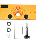 Front view of orange plastic hinge drilling jig with central drill guide and two black knobs; includes hex key and bits.