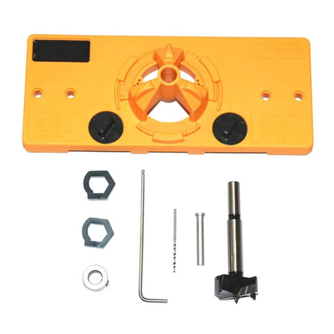 Front view of orange plastic hinge drilling jig with central drill guide and two black knobs; includes hex key and bits.