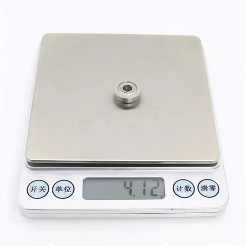 Premium 10 Pack Stainless Steel SF605ZZ Flanged Deep Groove Ball Bearings 5x14x5mm on digital scale showing weight.