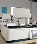 Automatic Metallographic Grinder Polisher Benchtop Machine For Pro Grade Specimen Prep Heavy Duty Lab Equipment seen from the side view in a lab setting.