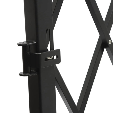 Close-up of Built Like A Tank Foldable Security Gate locking mechanism, showcasing iron construction and design details.