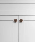 Antique brass cabinet pulls on white cabinet doors, part of 12 Pack Round Antique Brass Cabinet Pulls Single Hole Small Flat Head Metal Drawer Handles
