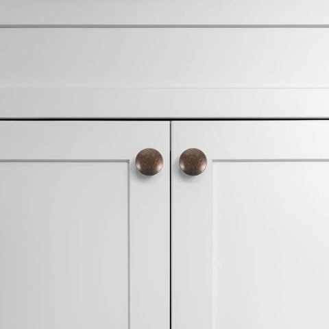 Antique brass cabinet pulls on white cabinet doors, part of 12 Pack Round Antique Brass Cabinet Pulls Single Hole Small Flat Head Metal Drawer Handles