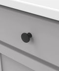 Close-up of solid metal core cabinet knob installed on a drawer, part of Solid Metal Core Cabinet Knobs And Dresser Knobs For Doors And Drawers One And Three Eighths Inch Black Iron Forge Collection Durable High End Hardware For Kitchens Bathrooms And Closets.
