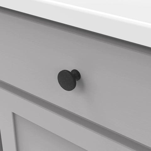 Close-up of solid metal core cabinet knob installed on a drawer, part of Solid Metal Core Cabinet Knobs And Dresser Knobs For Doors And Drawers One And Three Eighths Inch Black Iron Forge Collection Durable High End Hardware For Kitchens Bathrooms And Closets.