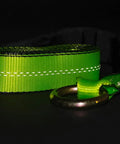 Close-up of a high viz green 4 Pack 2 Inch By 8 Foot Car Tie Down Ratchet Strap with chain anchor, 3335 LBS WLL, against dark background.