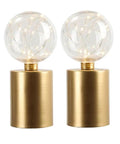 Pair of gold cylindrical lamps with clear glass globes and fairy lights