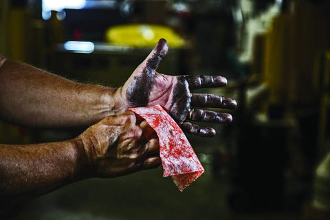 Person cleaning greasy hands with Grease Busting Heavy Duty Hand And Tool Wipes For Degreasing Hands And Work Surfaces, Waterless Cleaning With Vitamin E Aloe Lanolin, Fresh Citrus Scent, Multi Purpose Wipes, 82 Count.