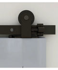 Close-up of Sliding Barn Door Hardware Kit 4 Ft To 20 Ft Rail System with industrial track and T style rollers hangers, mounted on double wood doors.
