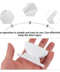 Premium 2 Pack White Rv Door Stop Retainer Tool For Motorhomes And Travel Trailers Holds Entrance Doors Securely In Place Prevents Slams While Camping Or Driving On The Road held in hand, showing easy operation.