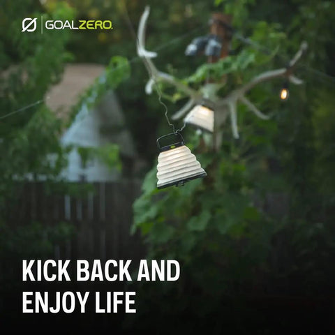 Crush Light Solar Powered Camping Lantern With Collapsible Design hanging outdoors on a string light for outdoor adventures.