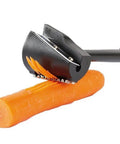 Front view of handheld spiral vegetable slicer with black body and metal blades slicing an orange carrot