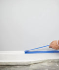 Applying Blue Painters Tape With PaintBlock For Sharp Lines to baseboard; 2 Inch Wide Painter Tape, Medium Adhesion, Ideal For Walls
