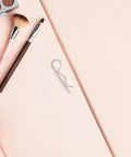 Heavy Duty Wavy Cotter Pins In Stainless Steel For Trailers And Hitches Easy To Install And Remove Locking R Shape Quick Pin on a pink surface.