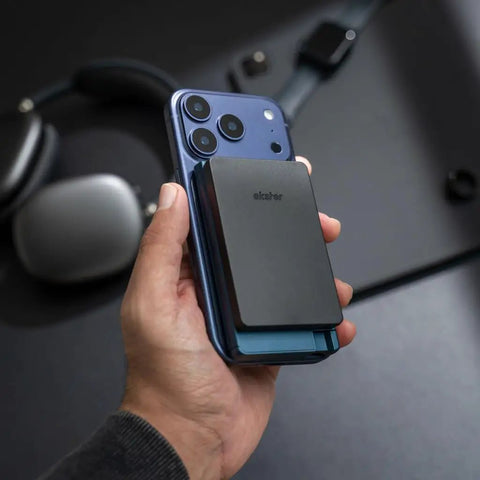 Hand holding iPhone with MagSafe Coin Tray With Cardholder Pro Attachment And Detachable Wallet Modular System installed.