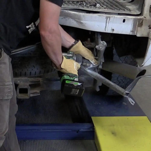 Person using 36V MultiVolt Half Inch Mid Torque Cordless Impact Wrench Workhorse Tool Only No Battery Four Speed Settings on car