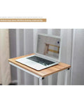 No Stress Rolling Laptop Desk And Mobile Workstation Stand Adjustable Tilt Table with a laptop on a wood surface.