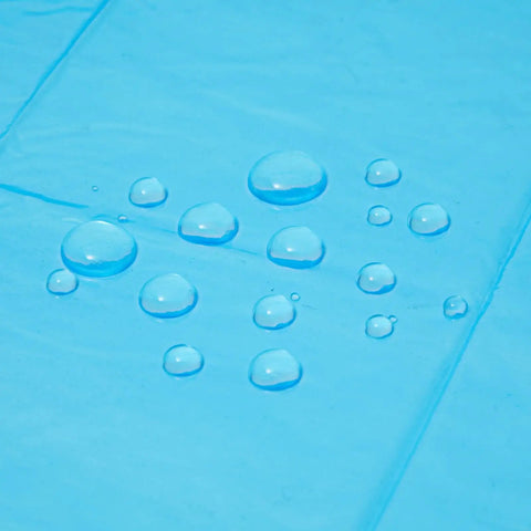 Close-up of blue Kids Rain Ponchos Pack Of 20 Disposable With Hood, Emergency Outdoor Gear For Rainy Days, water droplets on surface