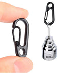 Black carabiner clip held next to a 30 lbs weight displaying the 30 Piece Mini Carabiner Clip Set, Tiny Zinc Alloy Spring Snap Hooks.