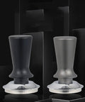 Top Shelf Black 51Mm Espresso Tamper With Adjustable Distribution Disk and Ergonomic Stainless Steel Grip, Two colors displayed.