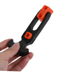 Hand holding a black and orange component of Beefy Heavy Duty Hood Latches Kit for Cars With T Handle Rubber Shock Absorption and Tool Box Latch Lock Down System That Keeps Your Engine Hood From Flying Open
