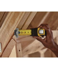 FatMax Auto Lock Tape Measure 25 Ft With 1-1/4 Inch Wide Blade Detachable End Hook in use measuring wooden beam