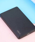 No Fuss 2.5 Inch SATA External Hard Drive Enclosure And Portable Docking Station With USB 3.0 Port For Laptops and SSD Drives on a colorful surface.