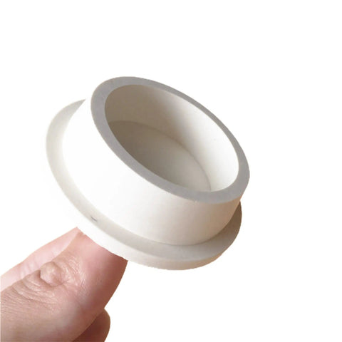 Close-up of hand holding a white rubber drain stopper from 3 Pack Rubber Drain Stopper Set For Bathtub And Sink That Fits Most Drains