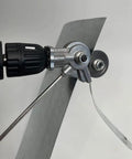 Upgrade Your Shop With This Electric Drill Shears Attachment mounted on a drill, cutting through a sheet of metal.