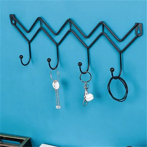 Black Wrought Iron Wall Mount Coat Hooks With Smooth Polish Heavy Duty Key Hangers on blue wall holding keys and accessories.