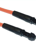 Close-up of two black connectors on orange cables for electronic equipment.